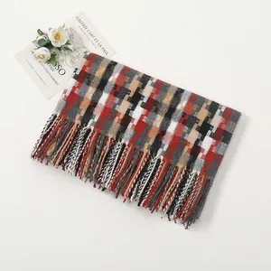 Detailed view of winter checkered scarf with long tassels and soft cashmere texture