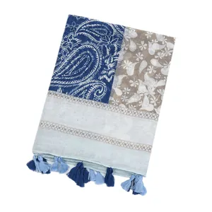 Close-up of vintage paisley print scarf featuring elegant blue tassels and soft fabric