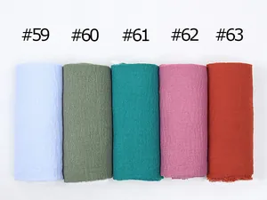 Detail of crinkle texture cotton linen scarves in various solid colors for women