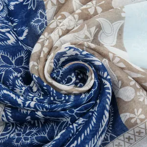 Detailed macro view of soft voile scarf with blue floral and bohemian patterns