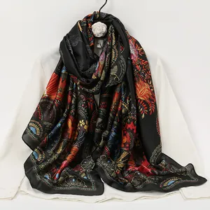 Detail of silk scarf showing ethnic patterns with red wings and golden floral prints