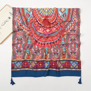Detail of bohemian geometric print scarf with dark blue tassels on white background