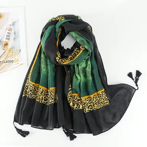 Detail of bohemian cotton linen scarf with leopard print and floral lace patterns