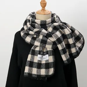 Detail of classic black and white plaid scarf with premium knit texture and woven brand label
