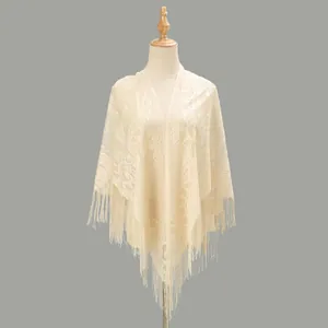 Close-up of the delicate hollow floral lace and tassel fringe on the ivory shawl