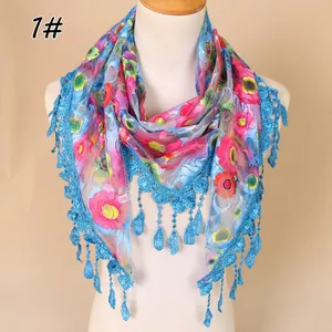 Detail of floral lace scarf featuring colorful patterns and teardrop tassel trim