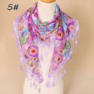 Detailed close-up of purple floral lace scarf with delicate fringe and sheer mesh fabric