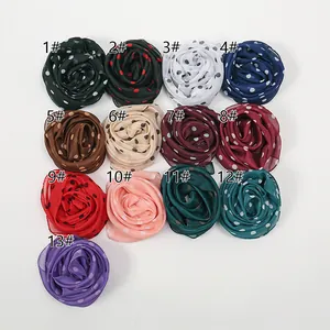 Detailed view of lightweight polka dot chiffon scarves in thirteen vibrant colors