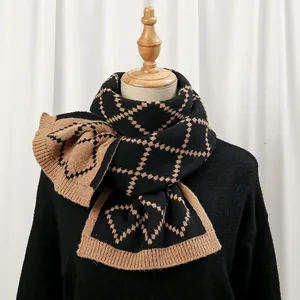 Detailed view of thick knit scarf with classic black and yellow argyle pattern and ribbed edge