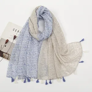 Detail of floral print scarf showing dual-tone fabric splicing and tassel fringe edges