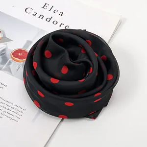 Elegant chiffon neck scarf with red polka dots on black fabric folded in floral shape