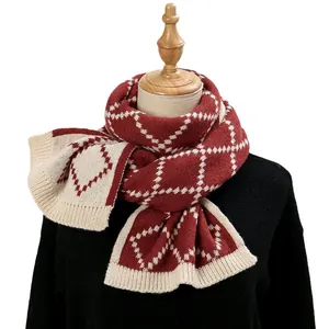 Classic red and beige diamond knit scarf with ribbed edges on a sweater mannequin