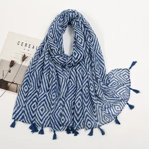 Detailed view of indigo geometric diamond pattern linen scarf with tassel fringe edges