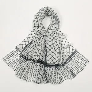 Close-up of geometric chiffon scarf featuring black lattice patterns and wavy edge details