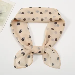 Close-up of lightweight apricot polka dot chiffon scarf with soft vintage tie knot detail