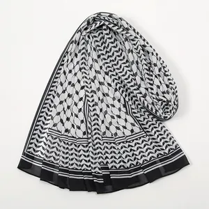 Detail view of lightweight chiffon scarf with classic black and white geometric pattern