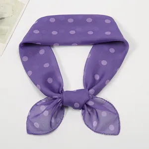 Detail of sheer purple polka dot chiffon scarf with professional machine-stitched edges