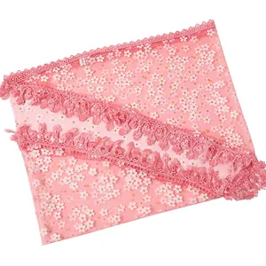 Pink floral lace scarf with white flower patterns and golden glitter accents
