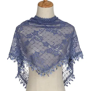 Detailed view of dark blue lace shawl with elegant floral embroidery and fringe trim