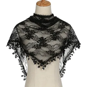 Detail view of black floral lace triangle scarf with delicate hollow-out embroidery and fringe