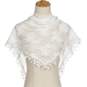 Detail of white floral lace triangle scarf with delicate fringe on a mannequin