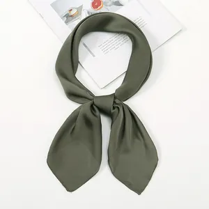 Detail of elegant olive green satin square scarf tied in a knot on white background