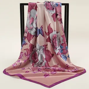 Detailed view of the smooth satin texture and floral rose print on the square scarf