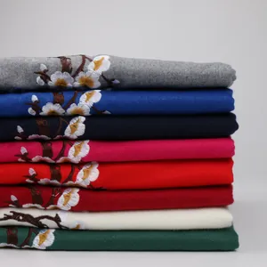 Detailed view of stacked cashmere-style scarves with plum blossom embroidery in 8 colors
