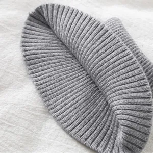 Detailed close-up of light grey ribbed knit texture on a winter double-layer neck gaiter