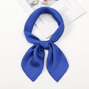 Close-up of royal blue satin neckerchief tied in a bow with smooth silk luster