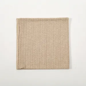 Detailed macro shot of the beige knitted winter neck warmer showing fine texture