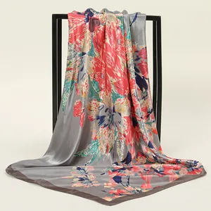Close-up of elegant floral print silk scarf draped on a black metal frame display
