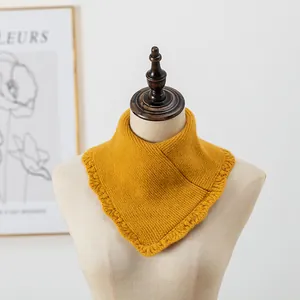 Détail d'un tour de cou tricoté jaune vif avec bords volantés sur un mannequin