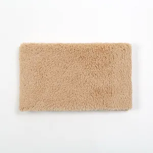 Close-up detail of soft camel-colored sherpa wool texture on a warm winter neck warmer