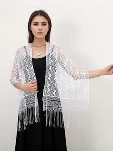 Macro shot of white lace shawl showing wave textures and hollow fringe details