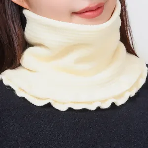 Women's cream knitted winter neck warmer featuring elegant ruffled edges and ribbed texture