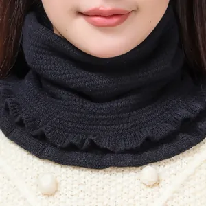 Detail of black knitted neck warmer with elegant ruffle edges for winter warmth