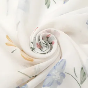 Elegant white floral scarf with cotton linen feel featuring delicate fringes and pastel print