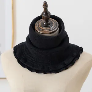 Detail of black knit thermal neck warmer featuring textured vertical wave patterns