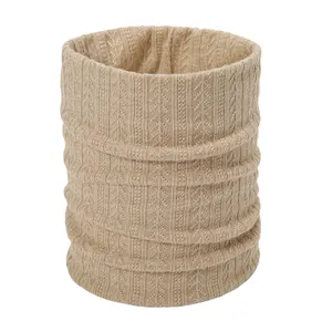 Close-up of beige cable knit neck warmer showing thick ribbed texture and soft yarn