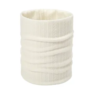 Detailed view of cream white knitted neck warmer with elegant vertical cable stitch pattern