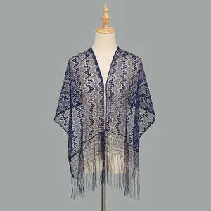 Close-up of navy blue lace scarf with wavy hollow patterns and long fringe tassels