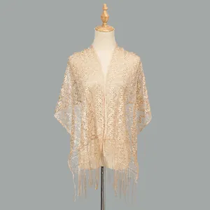 Detailed texture of champagne lace shawl featuring hollow patterns and long tassels