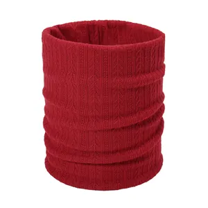 Close-up of red cable-knit winter neck warmer showing detailed ribbed texture and soft fabric