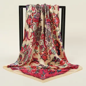 Close-up of bohemian floral silk-satin square scarf draped on a black frame