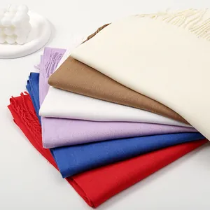 Minimalist solid color scarves with tassels in various colors like red and blue