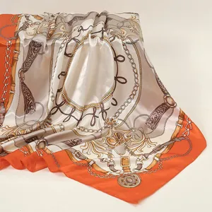 Elegant 90cm square silk scarf featuring luxury chain and rope patterns in orange and beige