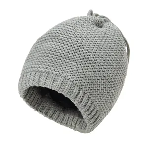 Detail of grey knitted winter hat with thick ribbed texture and warm fleece lining