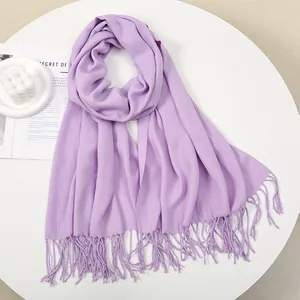 Detail of lavender scarf showing soft cashmere texture and elegant fringe tassels