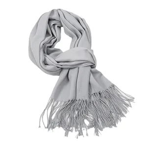 Light gray cashmere feel scarf with fringe tassels for winter warmth on white background